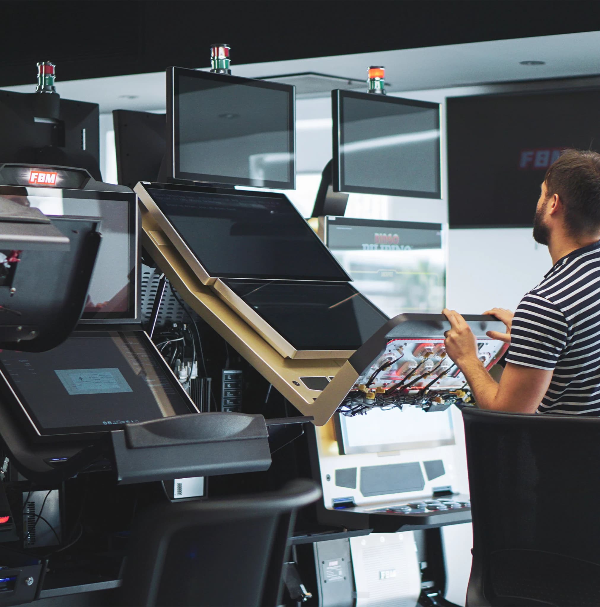 A professional adjusting the settings of an FBM casino cabinet