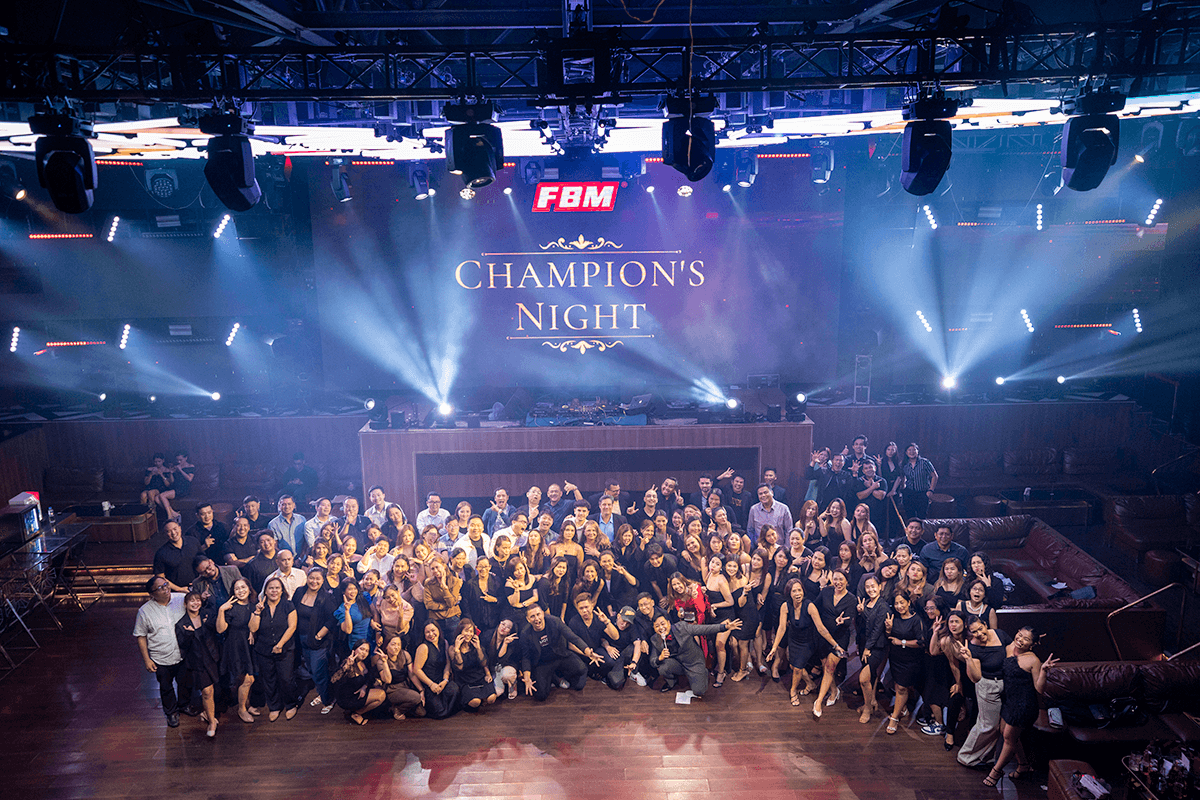 This image shows the FBM team and several bingo operators from the Philippines gathering for a photo in the FBM Champion's Night event.