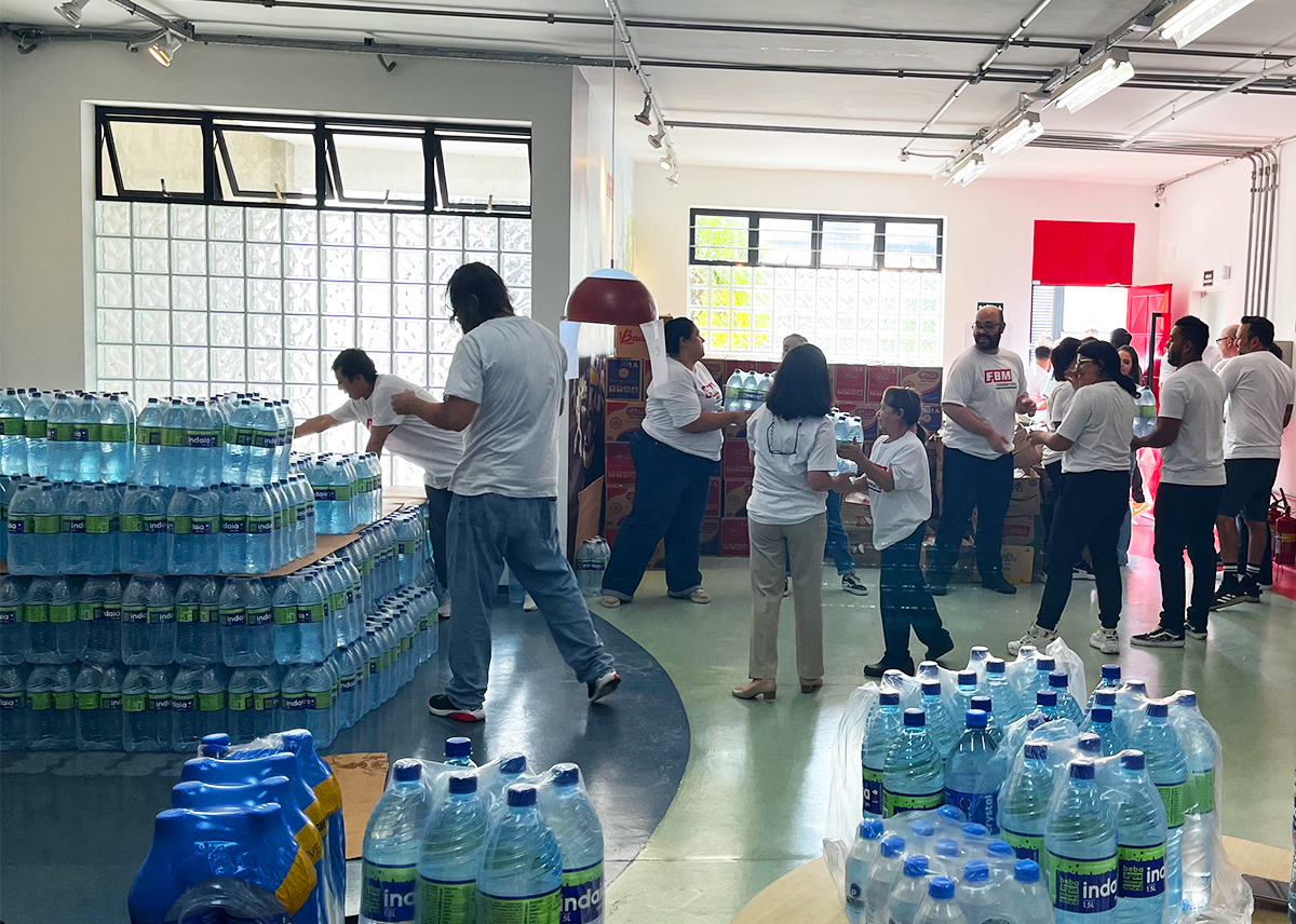 This image shows physical goods and the FBM Brazil team members making a collective effort to organize the FBM Foundation donation to Rio Grande do Sul.