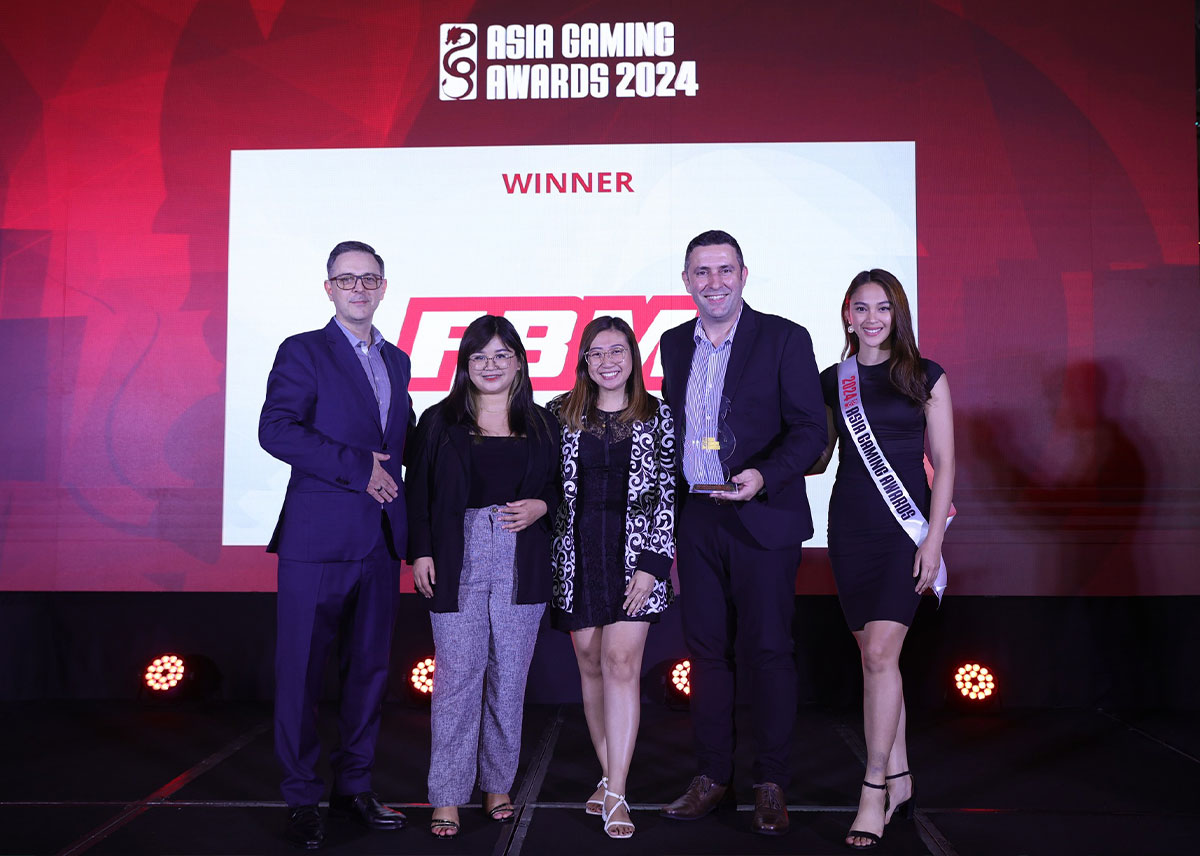 The image shows FBM and FBM Foundation representatives collecting the awards won at the Asia Gaming Awards 2024.