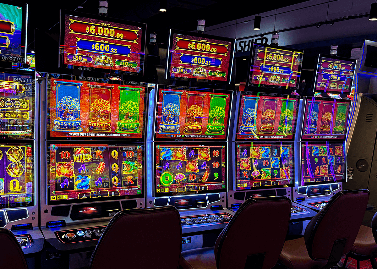 This image shows four Galaxy II casino cabinets of FBM running the Xing Fu Fortune Money Trees slot game