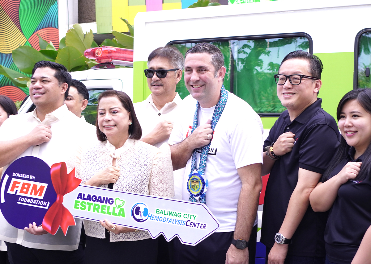 This image shows FBM Foundation and Alagang Estrella representatives delivering a big size key as a symbolic gesture of the ambulance donation. 
