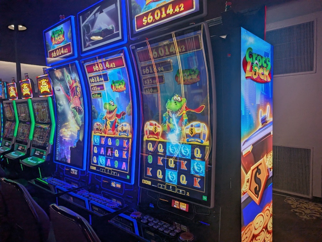 This image shows three FBM Auria casino cabinets runnning the Croc's Lock slots game.