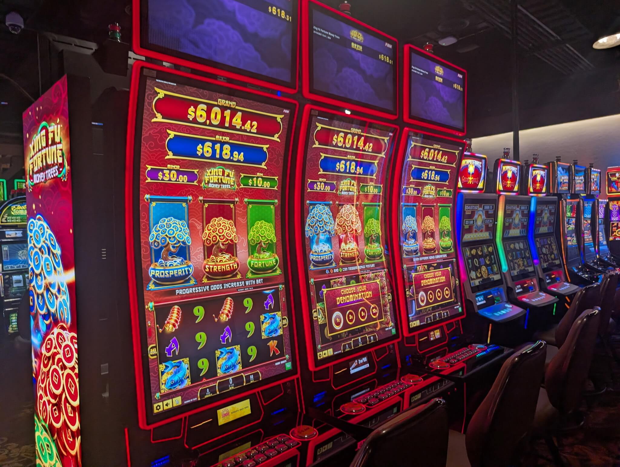 This image shows three FBM Auria casino cabinets running the Xing Fú Fortune Money Trees slots game.